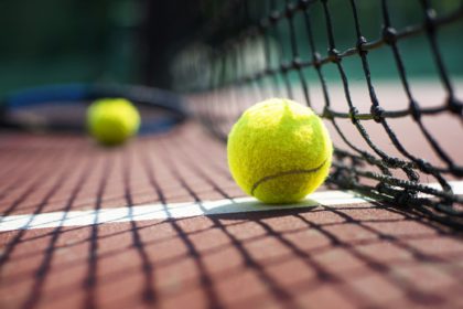 Tennis ball lying on the court. Healthy lifestyle concept